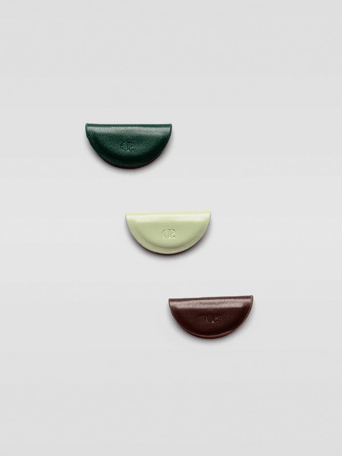 The same three bookmarks displayed flat and separated on a light gray background, showing their individual shapes and colors.
