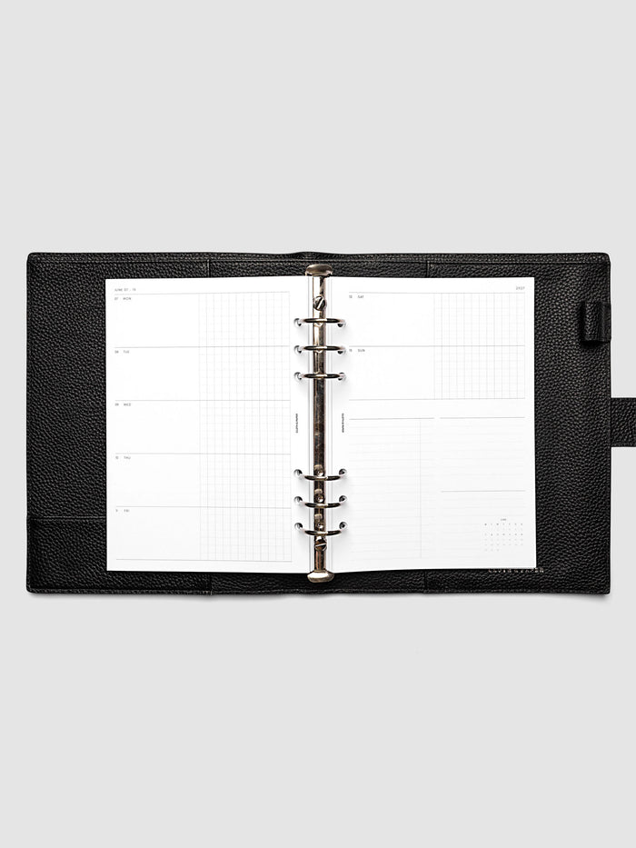 Open planner showing the full two-page 2027 Dated Weekly Horizontal Monday Start spread in A5 6-Ring Punch size, with split open and graph daily columns on the left and weekend dates, tasks, notes, and mini monthly calendar on the right