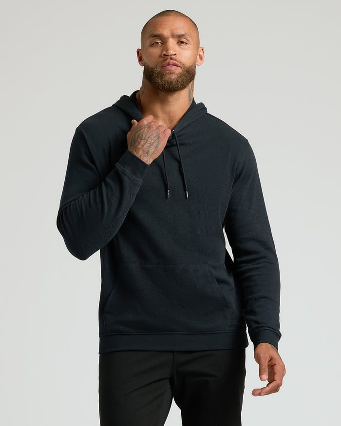 Male model in All Black Classic Waffle Hoodie.
