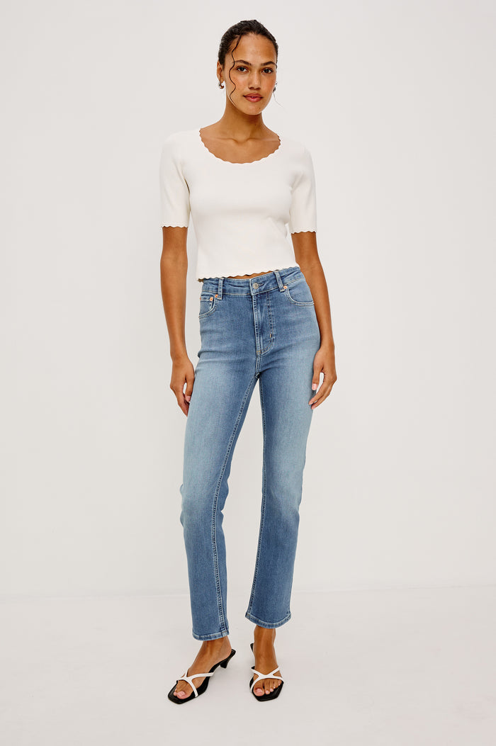 Bixby Mid-Rise Slim Straight Jean in High Stretch Denim With 25" Inseam, Zip Fly, and 5-Pockets in Vista Blue Colorway - Lower Body Close Up Back View Featured on Model