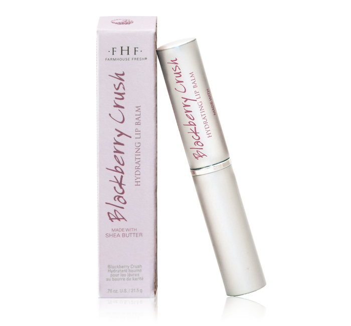Blackberry Crush Hydrating Lip Balm | Farmhouse Fresh product in a sleek silver tube next to its light purple box, highlighting skincare and lip hydration with shea butter.