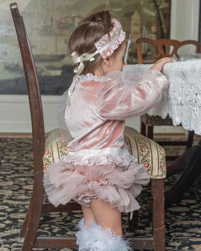 Side profile of Clara Pink Velour Jacket and Bloomers Set showcasing soft velour texture, ruffled waist trim, and voluminous pink tulle bloomers.