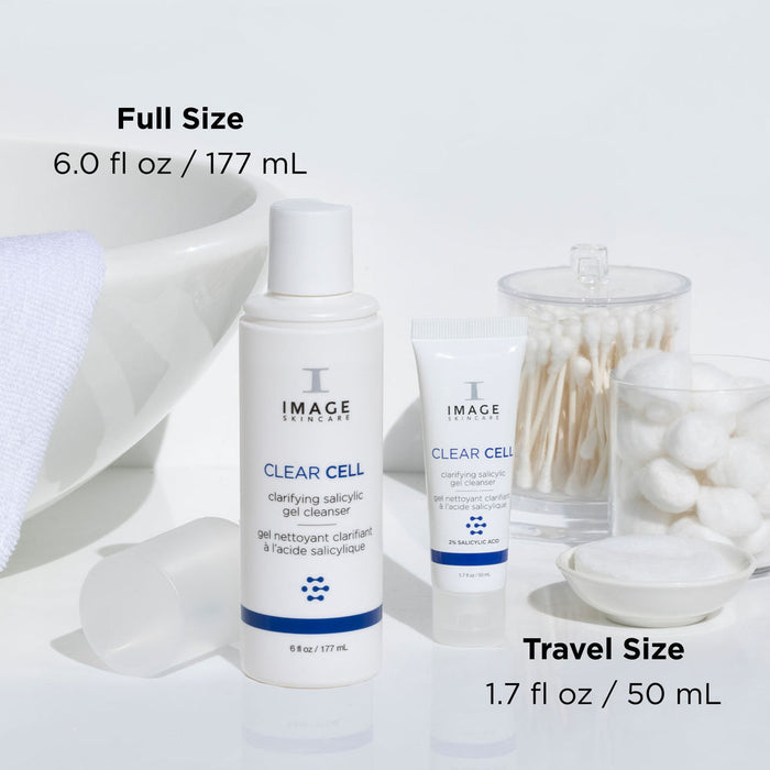 CLEAR CELL salicylic gel cleanser | IMAGE Skincare full size and travel size bottles displayed with cotton swabs, cotton balls, and a white towel in a clean skincare setting
