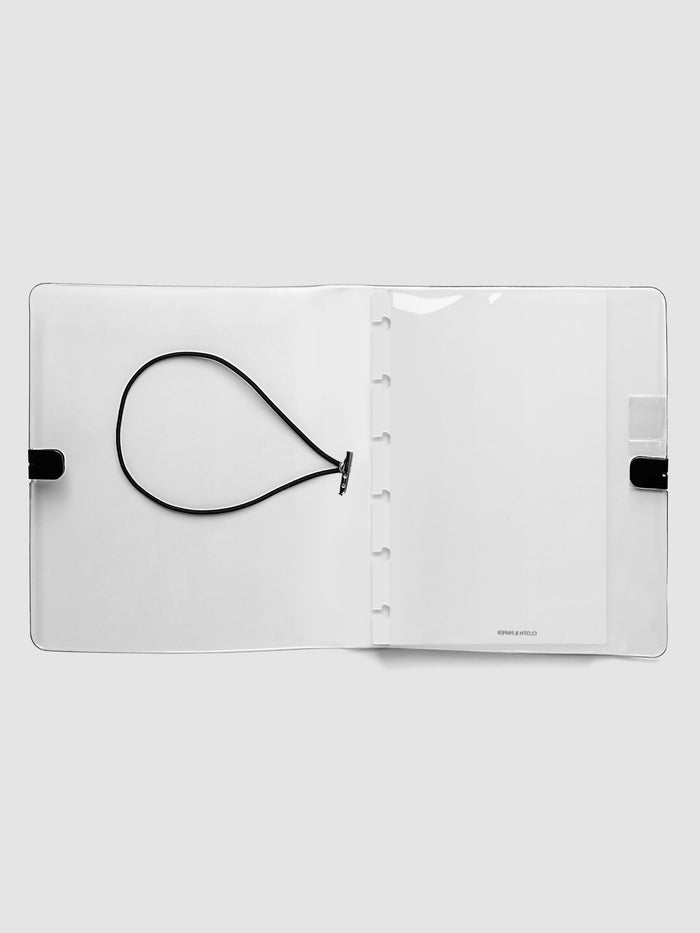 Clear Vinyl Planner Cover in size CP Petite shown open on a grey background.