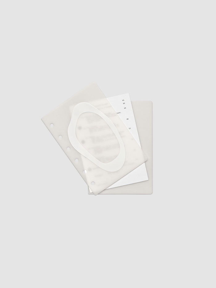 Continuation Planner Cover + Dashboard Set in Pocket. Milky white frosted plastic cover with a spot gloss organic shape over a black-printed paper dashboard. Image 2 of 3.