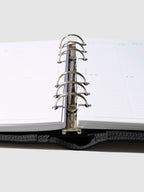 Close-up of the black leather agenda ring mechanism.