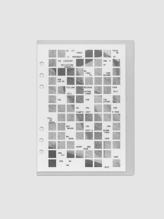 Clear planner cover with black printed text paired with a photographic black and white dashboard. Shown pre-punched for 6-ring planners in the size A5.