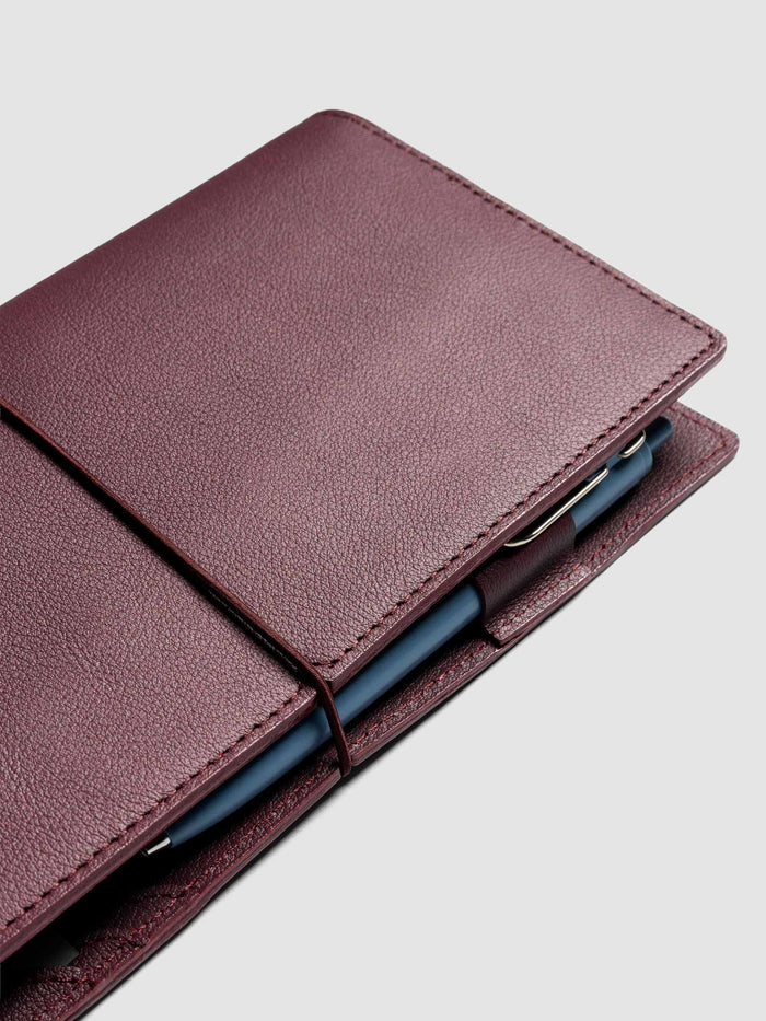 Deep red leather travel notebook cover in size A5 Slim shown closed.