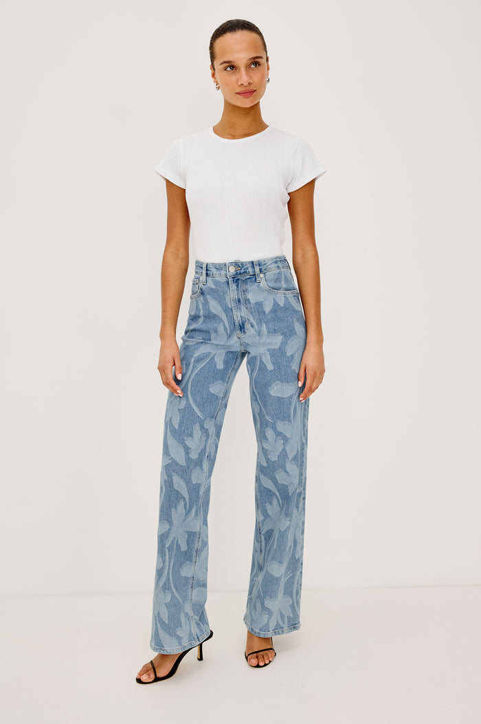 Getty Wide Leg Jean in Light Stretch Denim With High-Rise High-Waisted Fit, Button Fly, and 5-Pocket Styling in Floral Laser Colorway - Full Body Front View Featured on Model