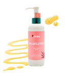 Bottle of Hand & Body Wash | Latika with wildflower scent, featuring a pink label and yellow liquid soap droplets, highlighting natural skincare and body care benefits.