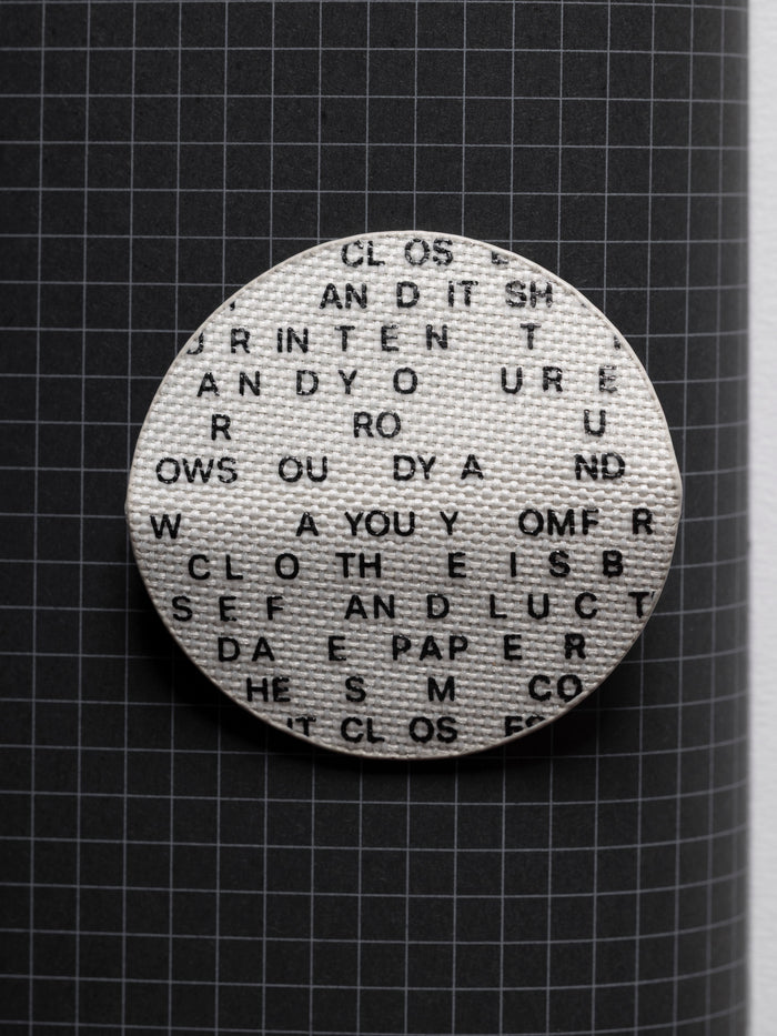 Magnetic Bookmark | Bookcloth | Letters unfolded displaying the bookcloth material and type design.