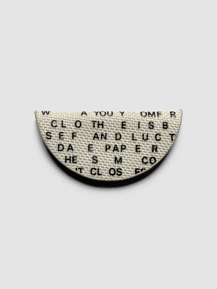Magnetic Bookmark | Bookcloth | Letters folded in half on a neutral background.
