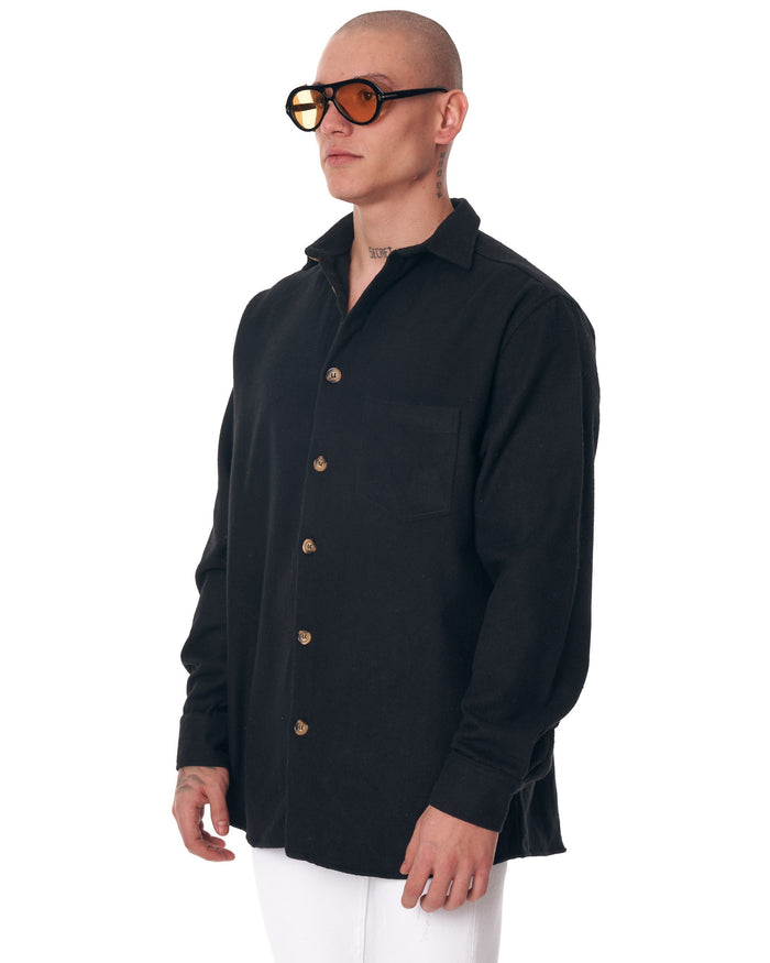 Martin Valen men's black lumberjack shirt worn, mid-body view showing chest pocket and contrasting buttons