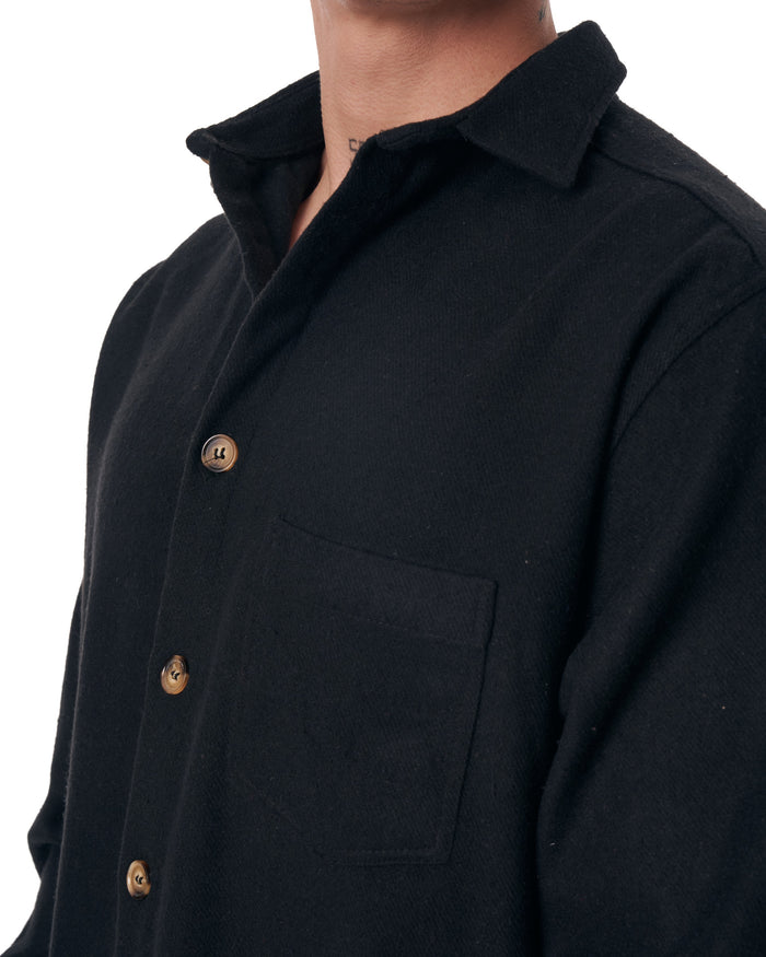 Martin Valen men's black lumberjack shirt, close-up of collar and chest pocket showing brown buttons