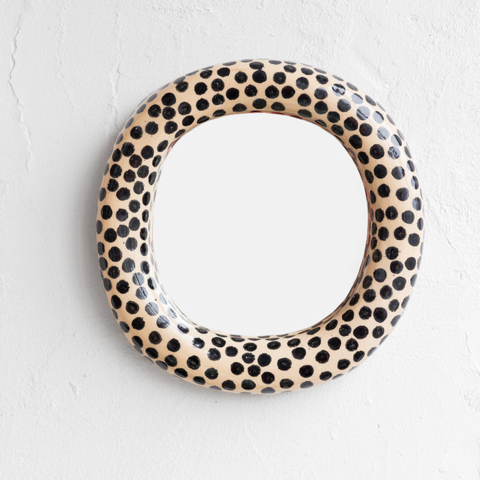 Round ceramic plate with black dot pattern