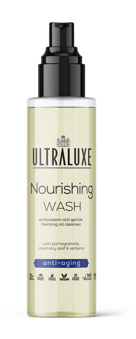 Clear pump bottle of Nourishing Wash | Ultraluxe Skincare with pale yellow gentle foaming oil cleanser, labeled antioxidant-rich with pomegranate, rosemary leaf, and verbena for anti-aging skincare.