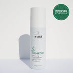 Bottle of ORMEDIC® balancing facial cleanser | IMAGE Skincare with a clean white design and an improved formula badge in the background, promoting skincare and wellness.
