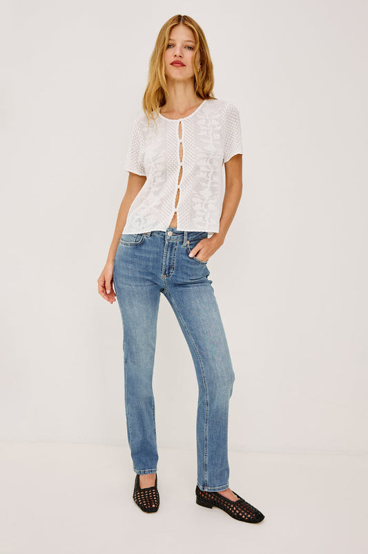 Bixby is a 5-pkt slim straight jean in Vista Blue colorway. Front view featured on model.