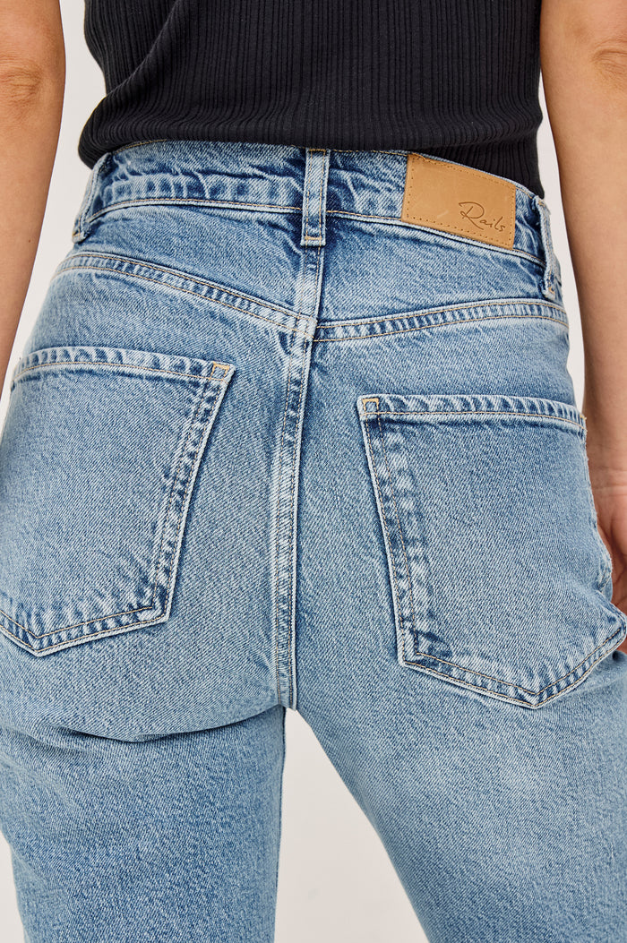Topanga Petite High-Rise Wide Straight Leg Jean in With 5-Pockets and a Front Zip-Fly in Old Indigo Colorway - Close up View Featured on Model
