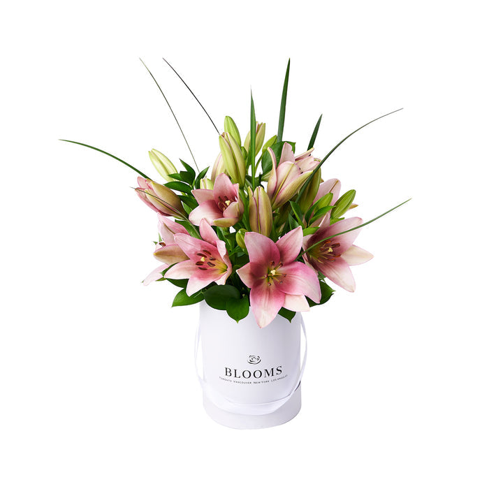 Pink Lily Floral Arrangement in White Hat Box – gift basket with this beautiful arrangement features a selection of lilies