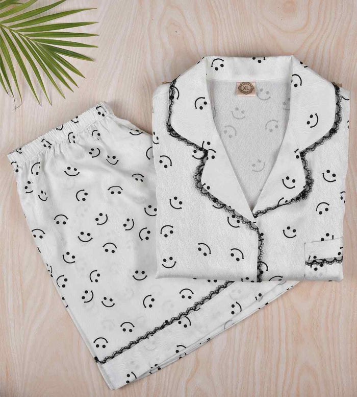 White satin pajama set: button shirt and shorts with smiley print, lace-edged trim