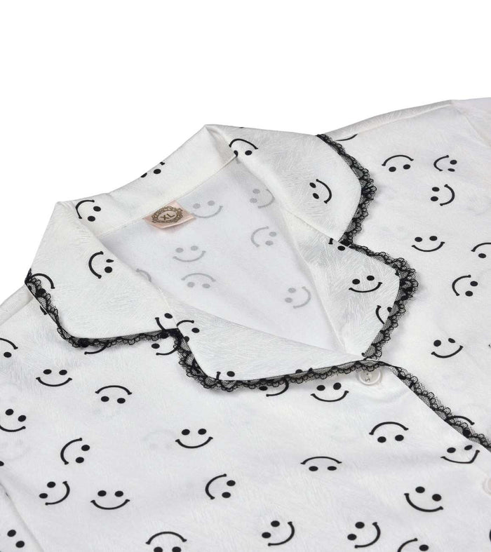 White button pajama shirt with smiley print and black lace-trimmed collar