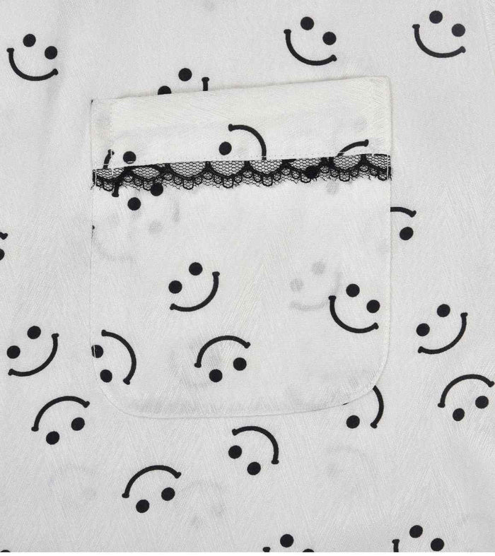 White pajama shorts with smiley print, elastic waist, black lace trim panel