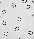 White satin fabric with black smiley face print
