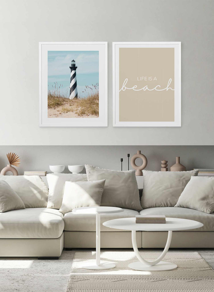 Striped Watchtower is a minimalist photography of a sandy pathway covered in beach grass leading to a swirled black and white tall lighthouse by Opposite Wall.
