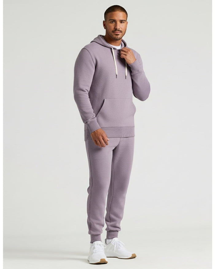 Model wearing Thistle Fleece French Terry Pullover Hoodie and joggers.