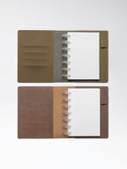 One Cipher and one Espresso folio displayed opened on a neutral background. Discbound planner systems are shown in use in each folio.
