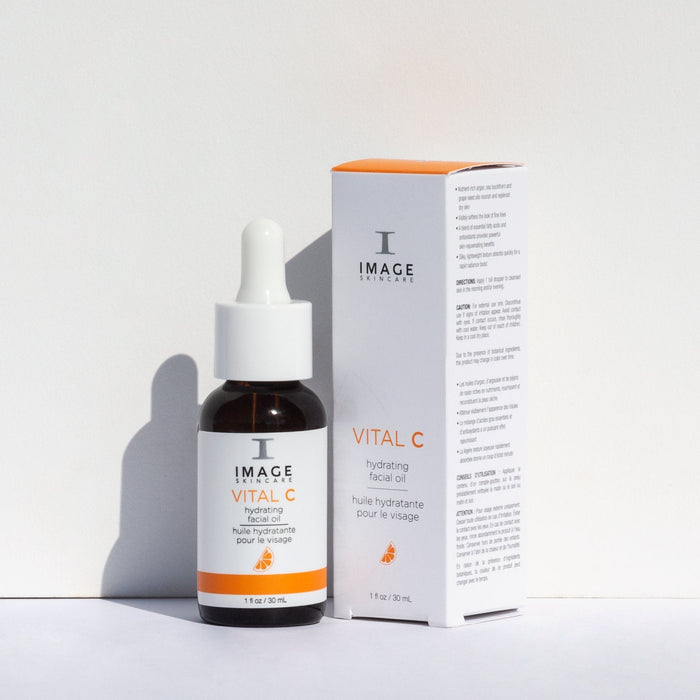 VITAL C hydrating facial oil | IMAGE Skincare bottle with dropper and matching white and orange packaging, designed for skincare hydration and nourishment.