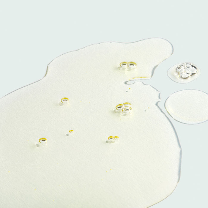 Clear, lightweight facial oil with visible droplets on a light surface, representing hydration benefits of VITAL C hydrating facial oil | IMAGE Skincare in a skincare context.