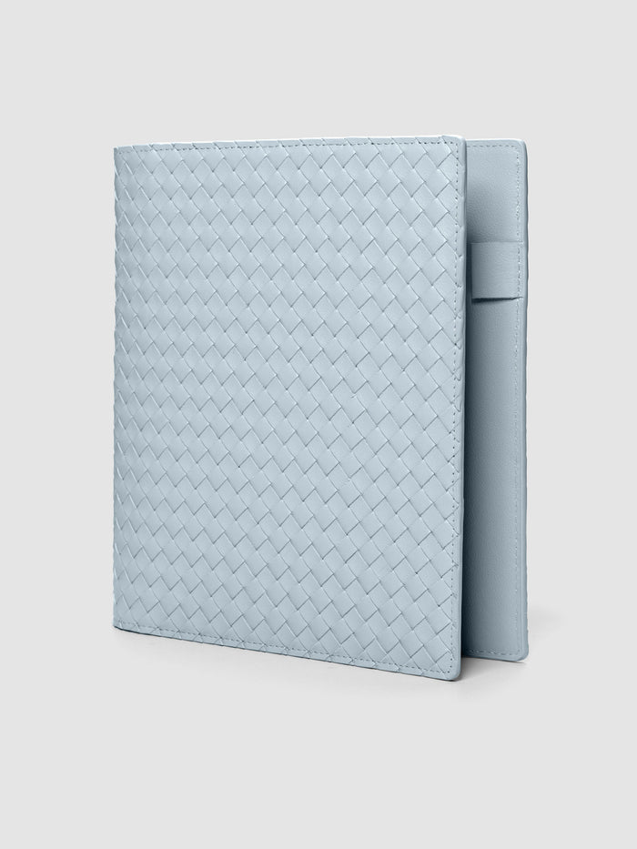 Blue woven leather planner cover shown standing at an angle.