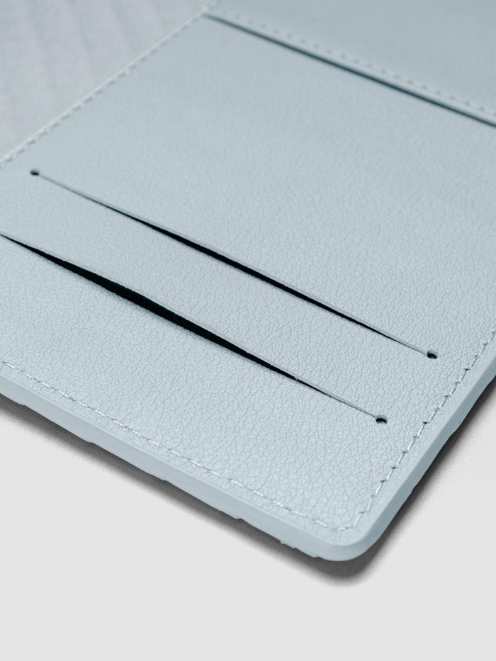 Blue leather planner interior showing two credit card slots and a pocket.